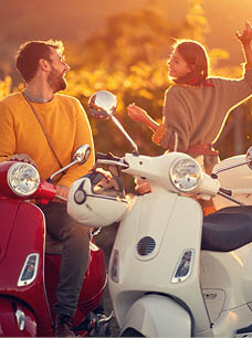 romantic journey on scooter at beautiful sunset on vacation. 